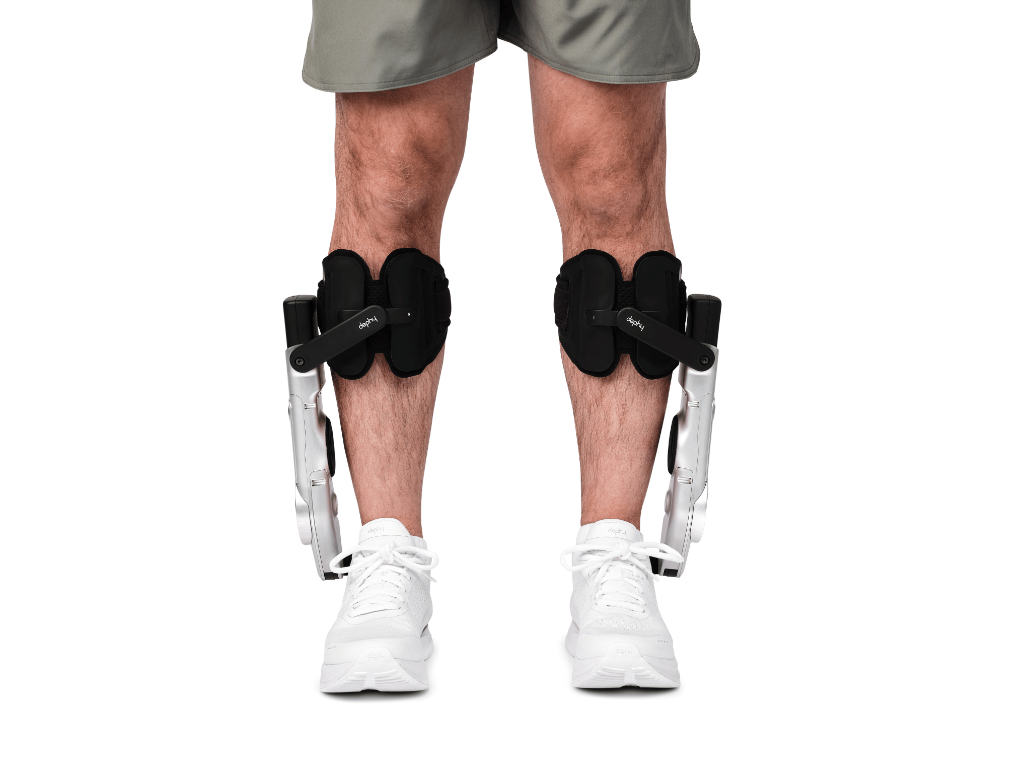 Person wearing black Sidekick device and white sneakers on a white background